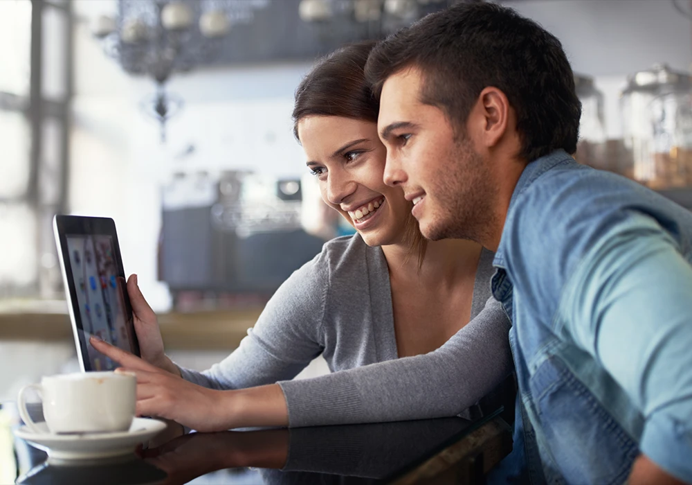 young couple looking at an ipad